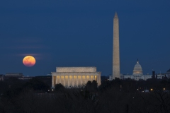 A colorful moonrise over the National Mall.