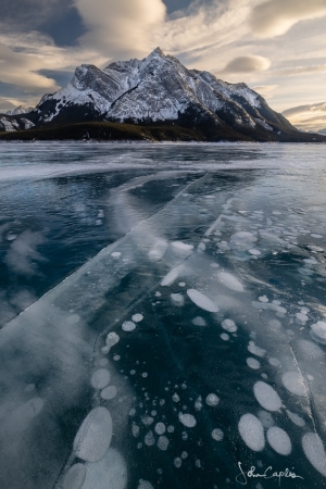 Criss-crossing ice cracks in from of Mount Michener