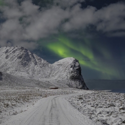 Aurora over the road at Unstad Beach