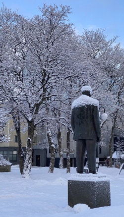 Snow covered statue and trees in Svolvaer - iphone